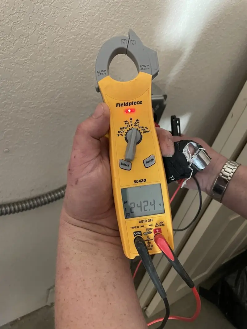 Voltage testing with clamp meter during Electrical Installation Services in Highland Park